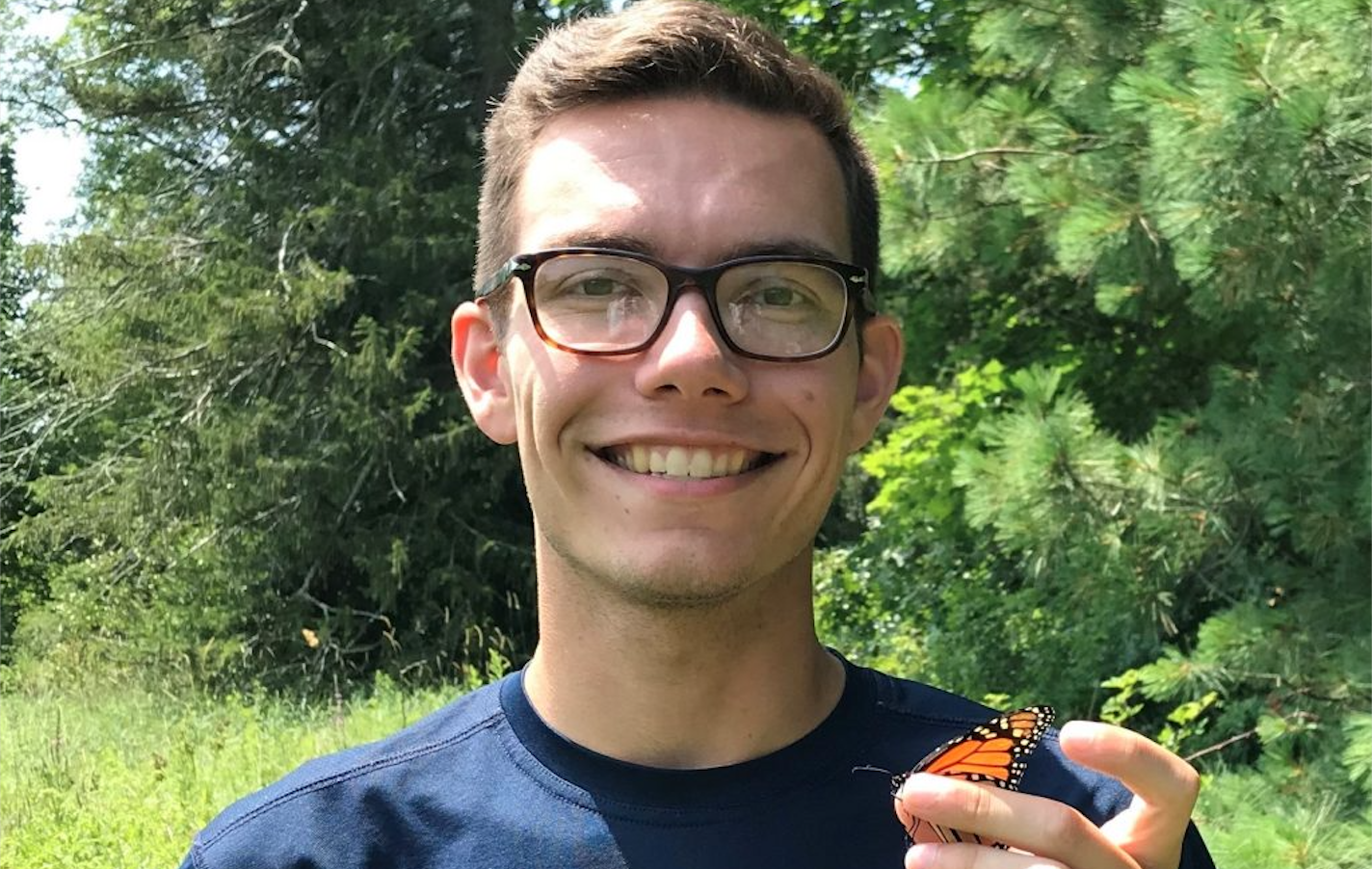 James Michielini holding a butterfly  