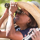 Helene Dillard looks through binoculars