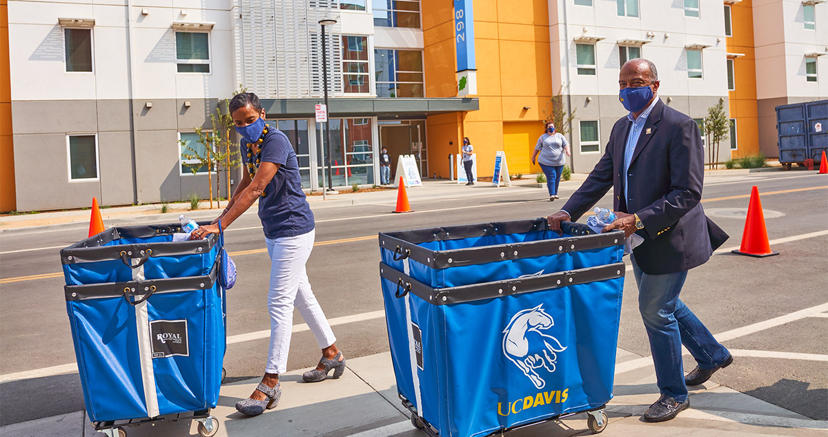 LeShelle May and Gary S. May push carts.