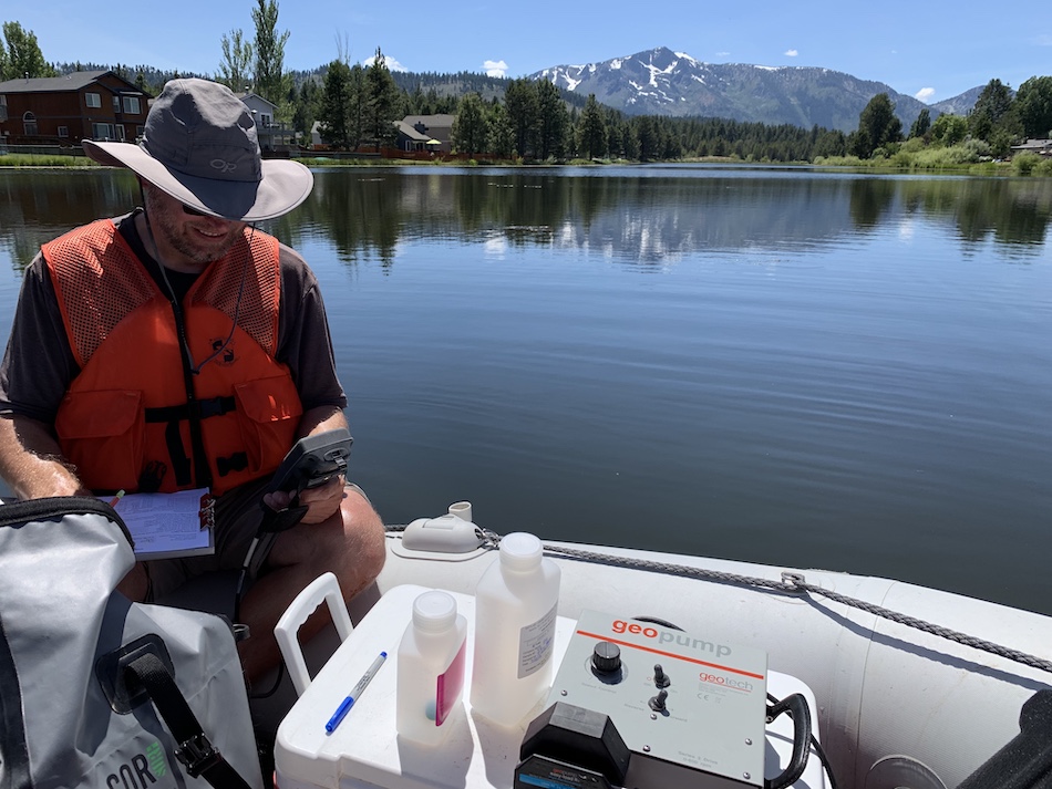 An environmental planner conducts water sampling.