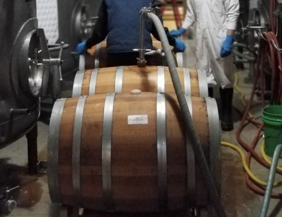 Ben Carignan (left) and colleague rinsing barrels and racking Anchor Porter aged in whiskey barrels. (Photo courtesy of Anchor Brewing Company) 