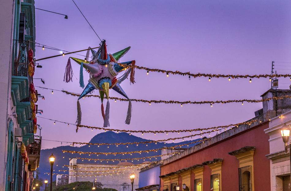 A Mexican skyline with decorations and a sparkling posada star