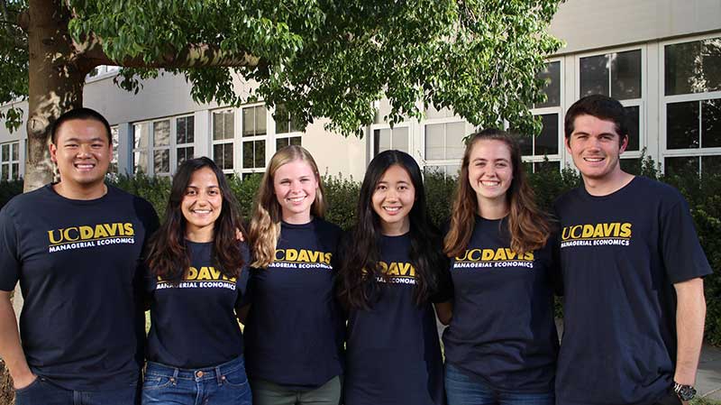 Students in UC Davis T-shirts pose for a photo