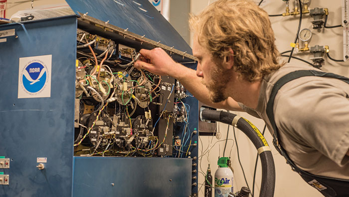 A man adjusts controls on a machine