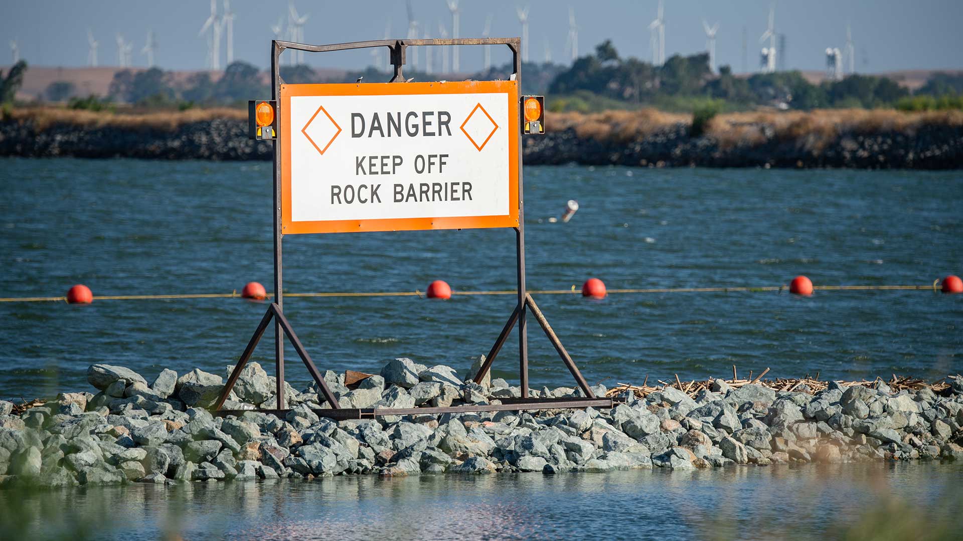 A rock barrier spans a river