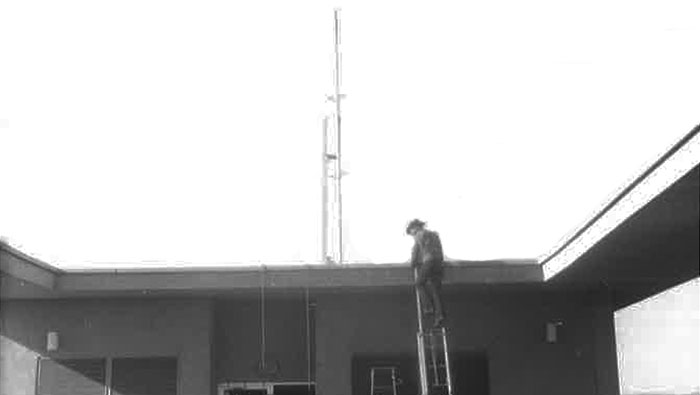 Norm Wohlers on ladder by the old antenna