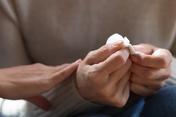 Hands holding tissue