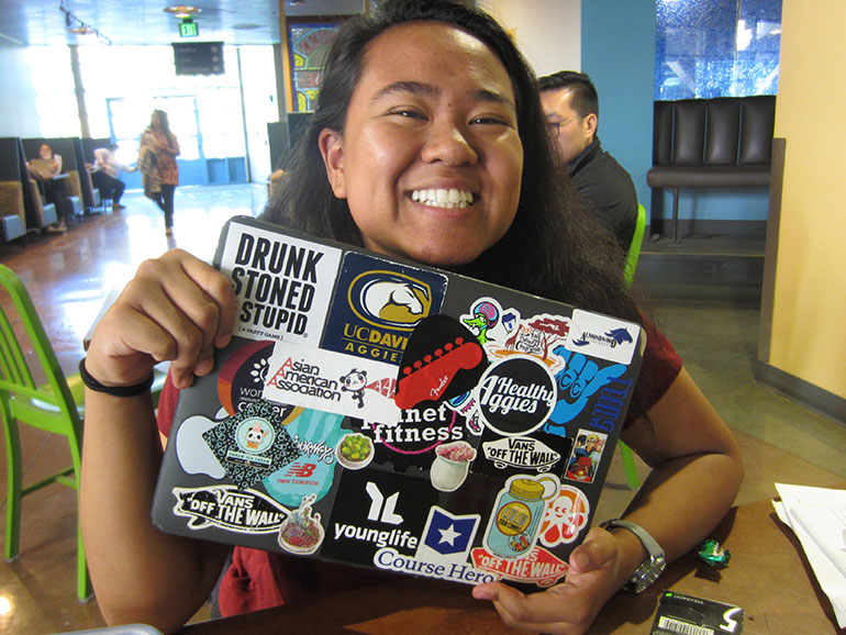 Raziel Ramil holding her laptop