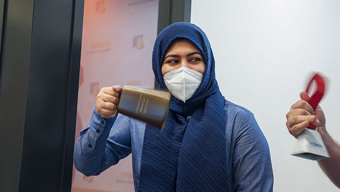 Fatima Hussain rings the Graduate Studies bell