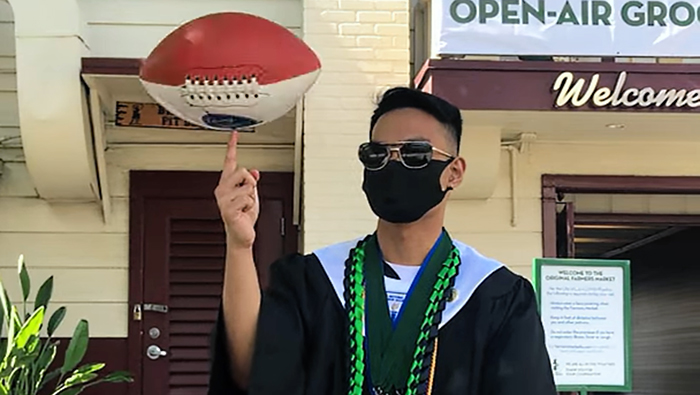 Meo Cantiller spins a football on his finger