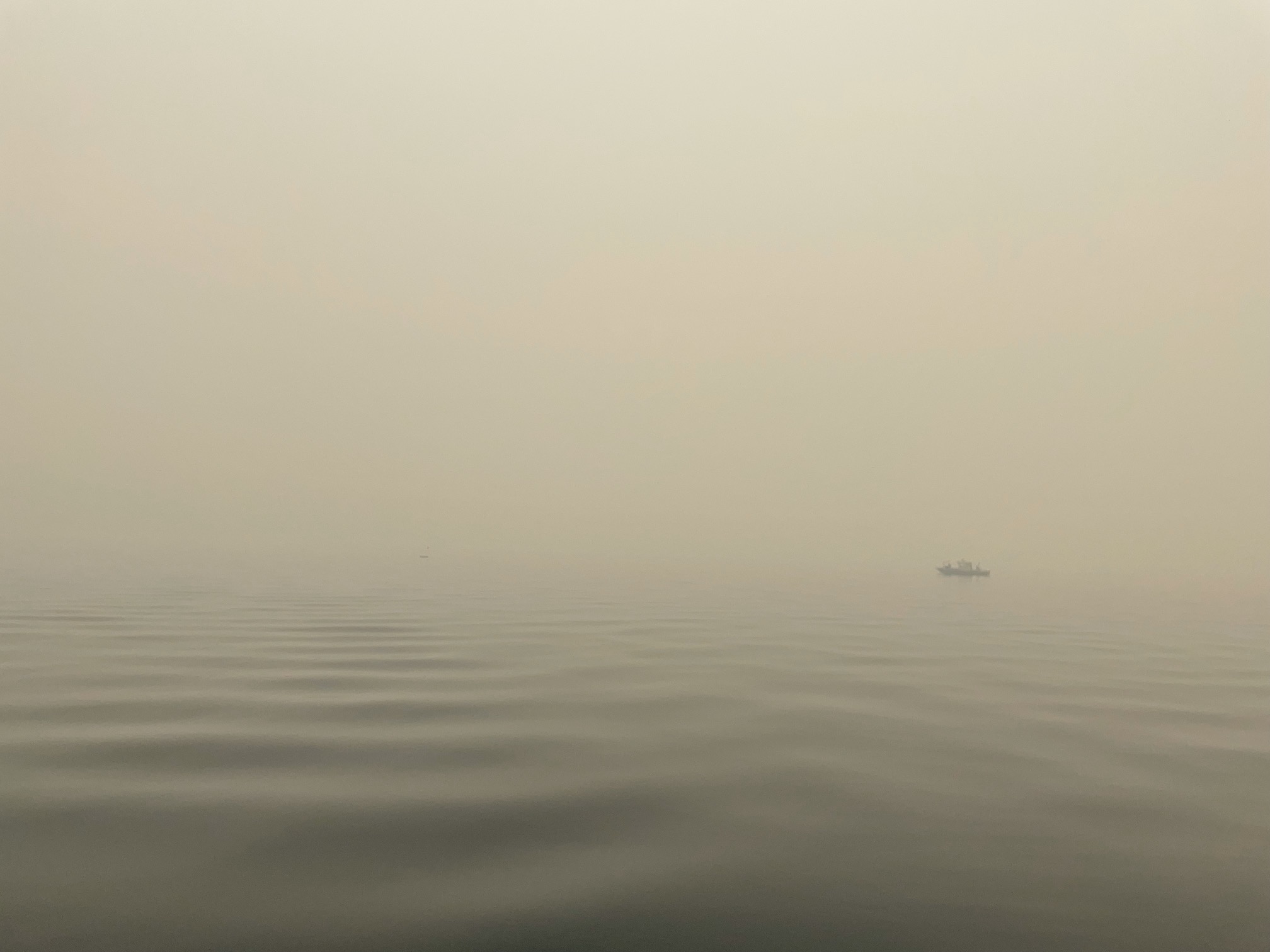 Smoke and haze inundate the air above the surface of Lake Tahoe in August 2021
