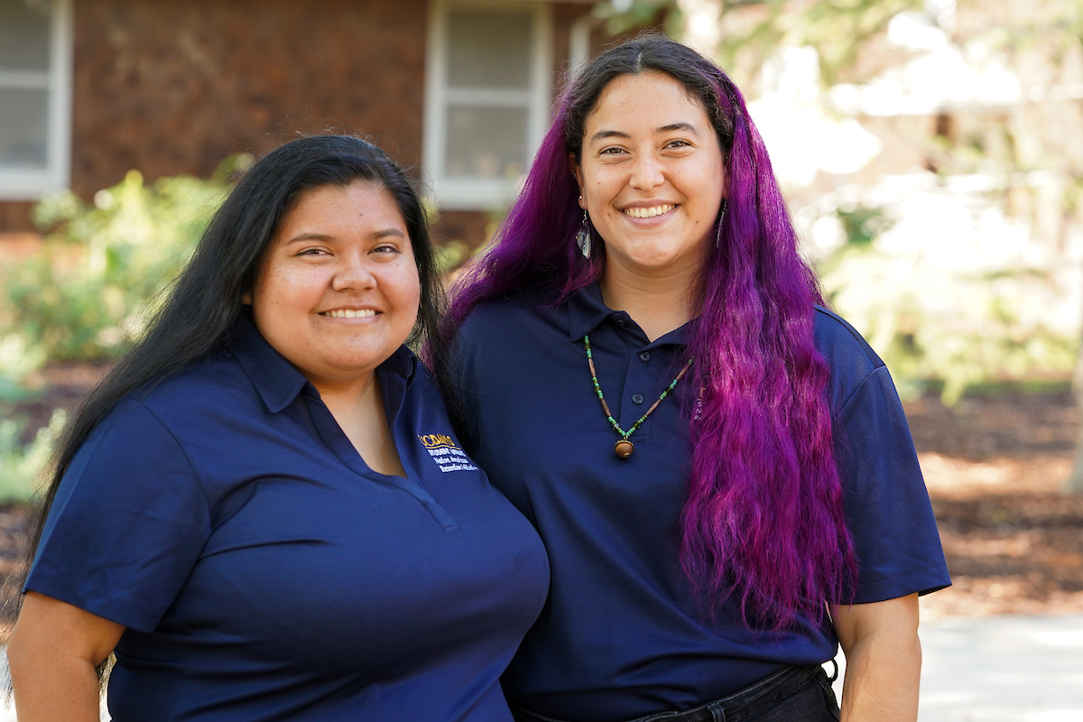 Two students smile on campus at UC Davis. 