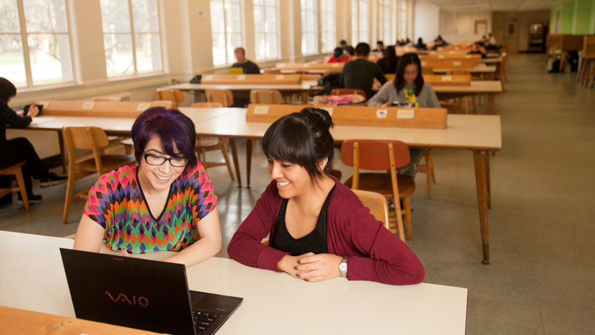 two students study in the UC Davis Shield's Library 24 hour study room