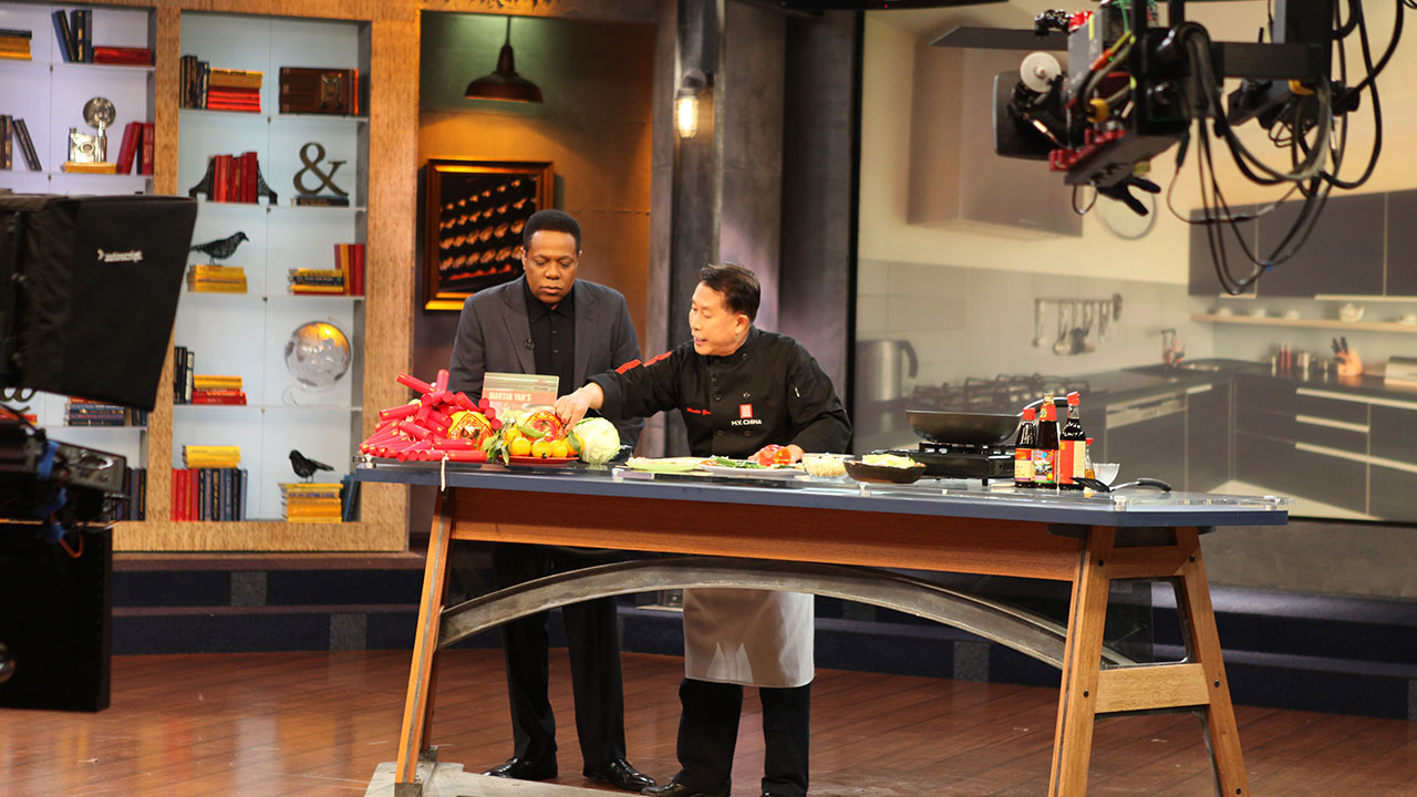 Martin Yan sets up a cooking demonstration in a television studio