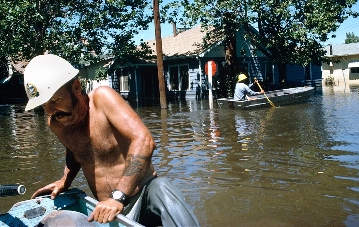 Historical image of emergency workers wading in water in Isleton following 1972 flood