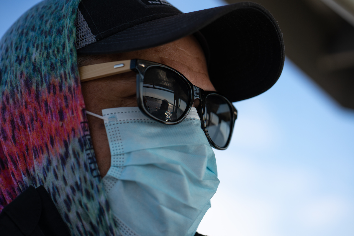 Levi Lewis in mask, sunglasses and ball cap