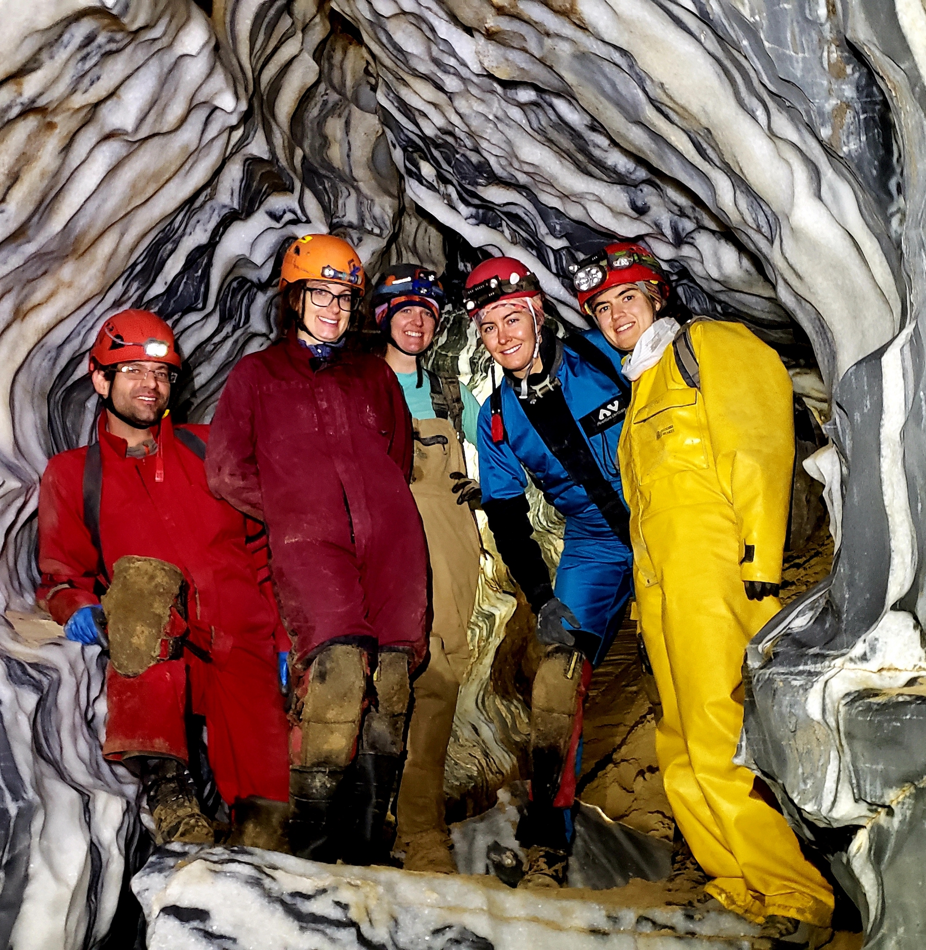 Five UC Davis researchers inside marble rock formations of cave
