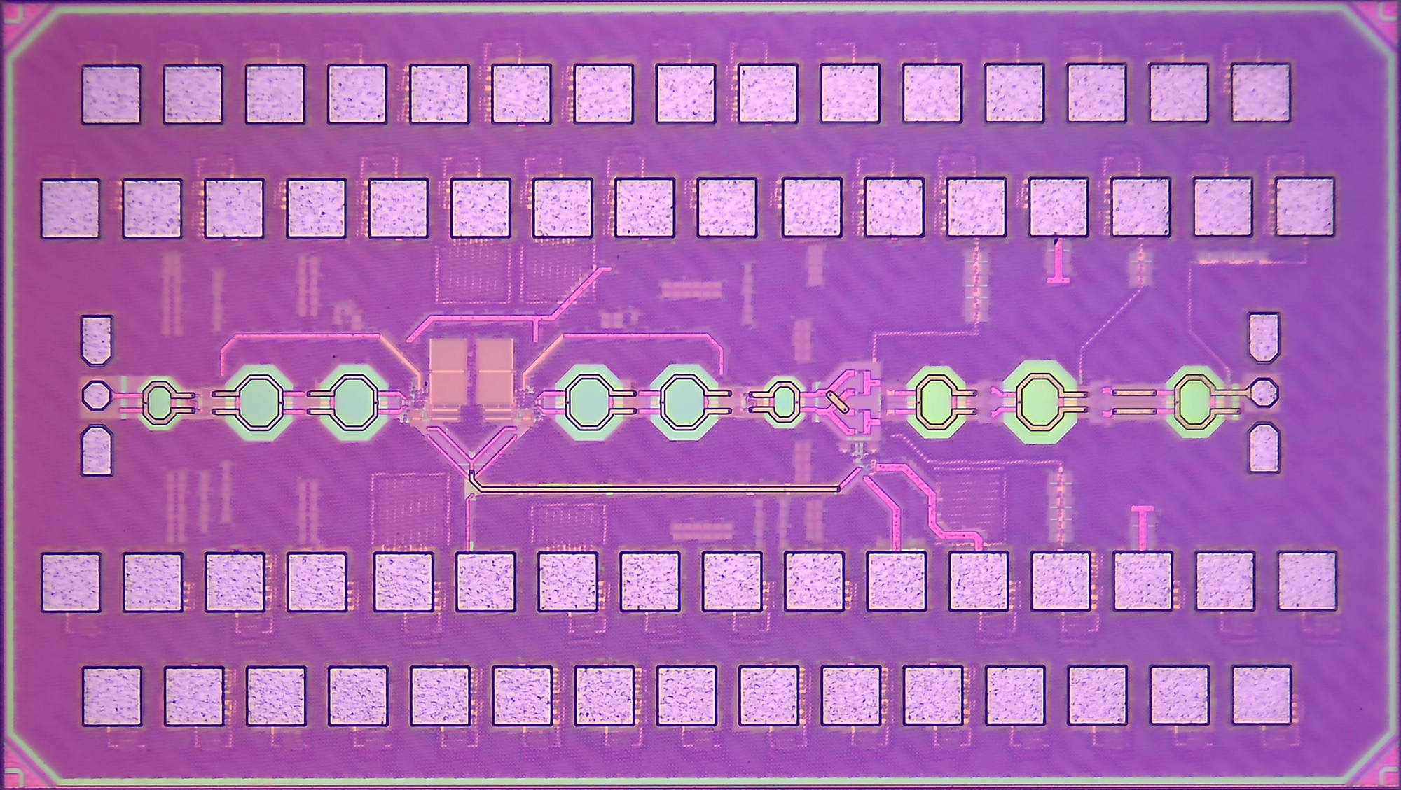 A circuit board with rows of squares against a mauve background. 