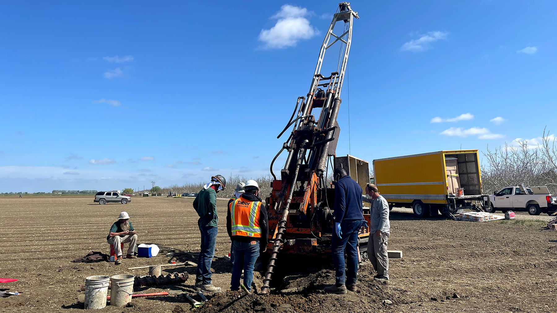 UC Davis researchers in a farm field insert a tube-like groundwater monitoring device to measure nitrates. (Isaya Kisekka/ UC Davis)