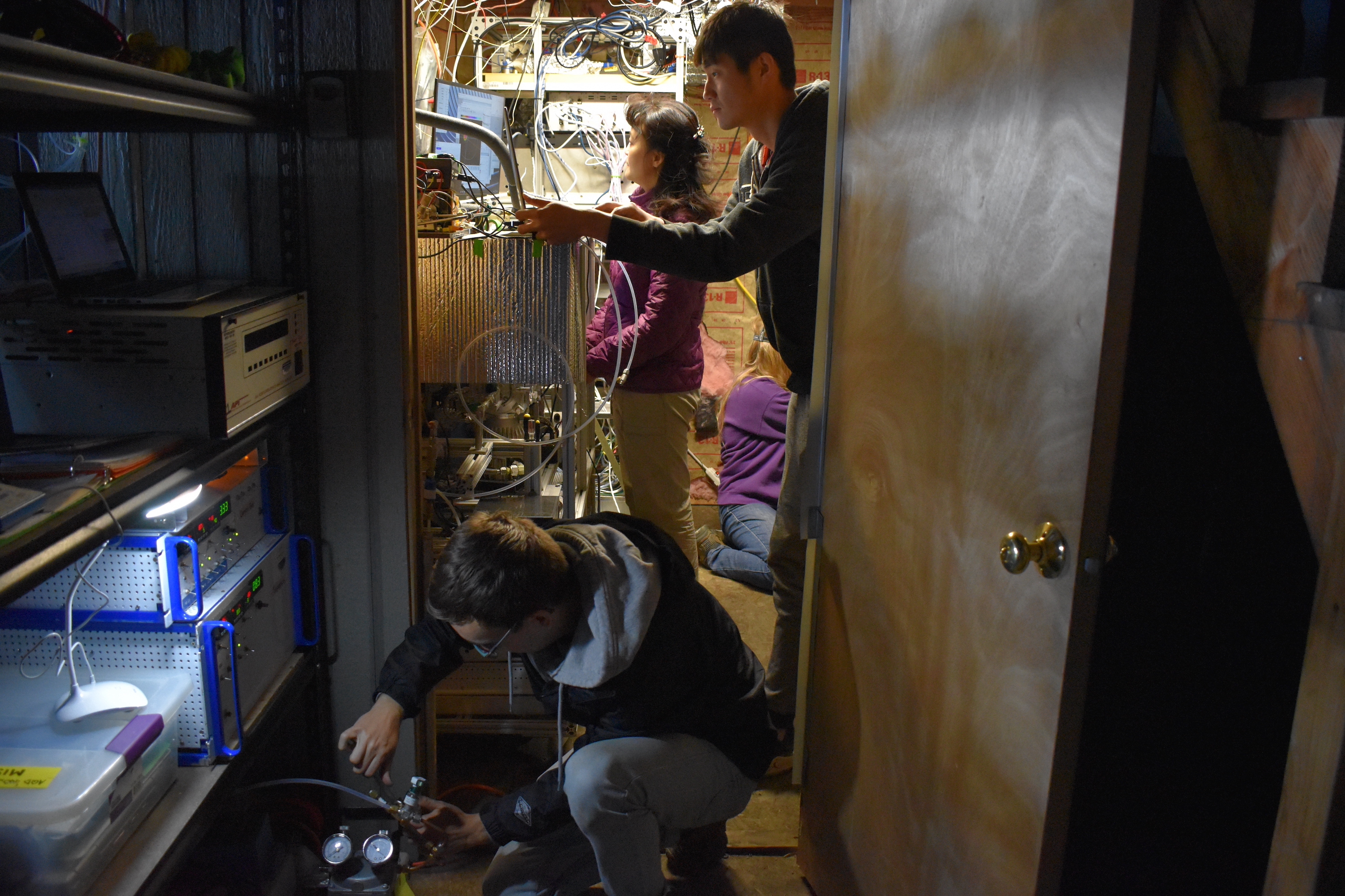 Scientists set up instruments for real-time ambient sampling in a dim room at the Mount Bachelor Observatory in Oregon 