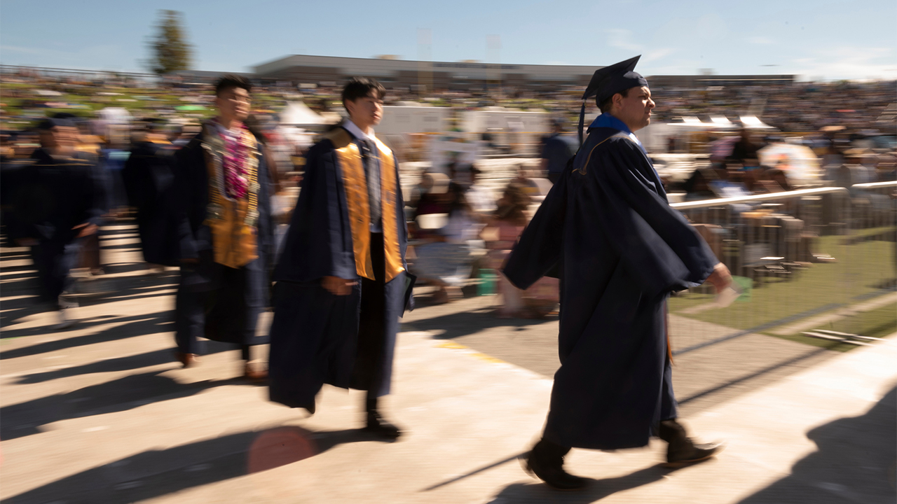 Graduates file into UC Davis Health Stadium on June 10. 