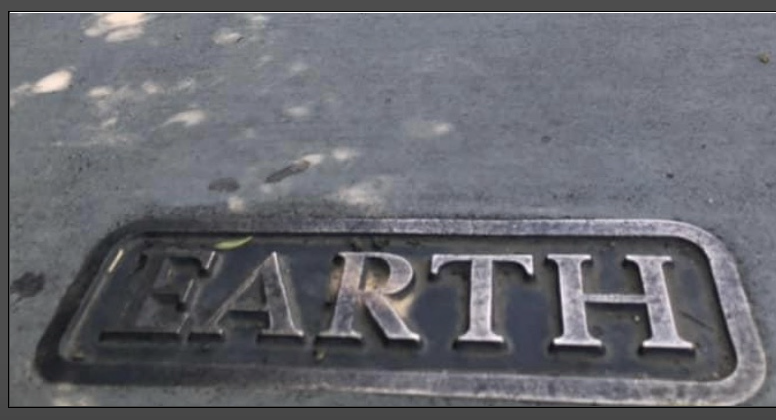 Bronze plaque that says "earth"