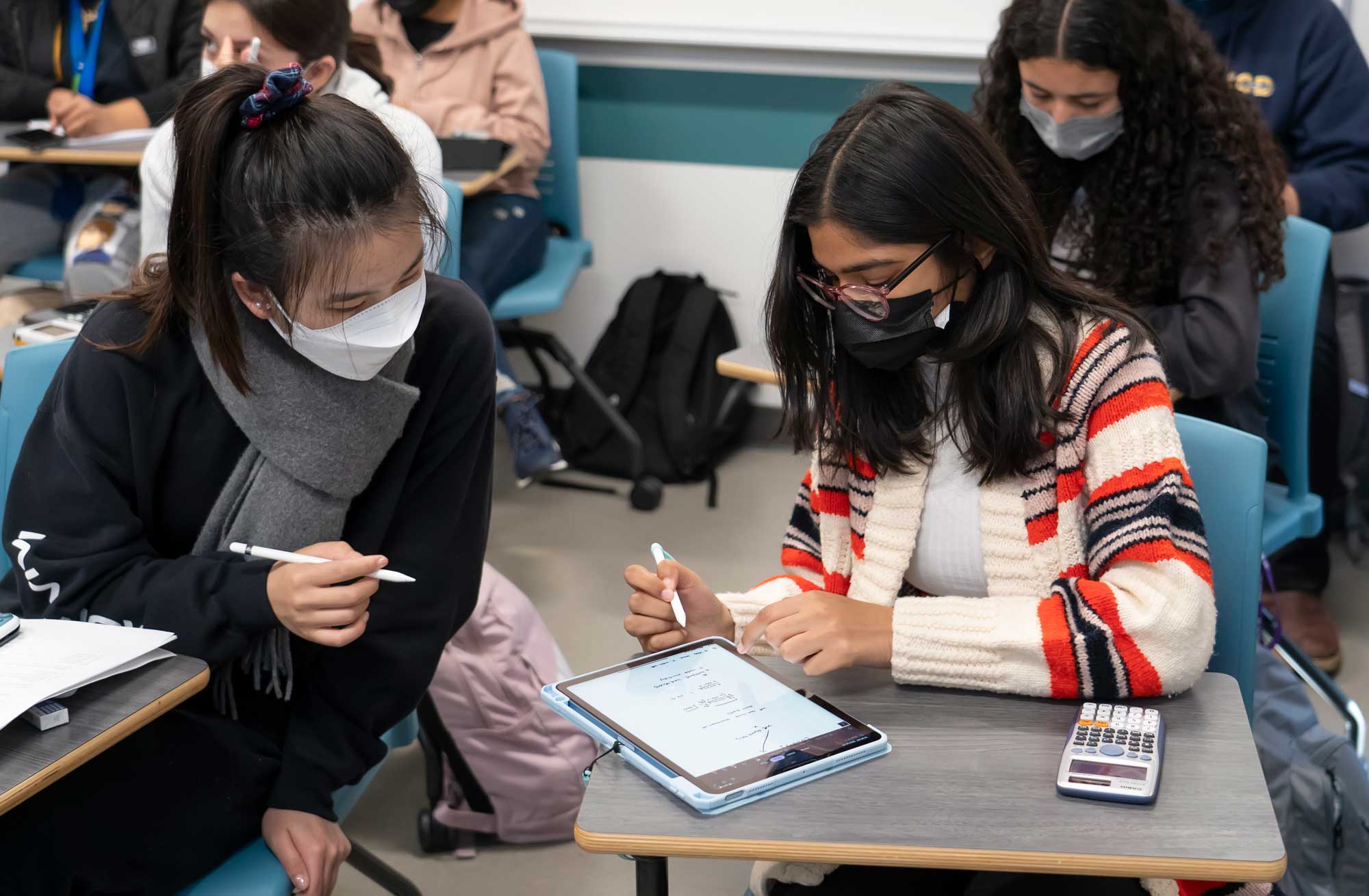 Students Mamta Rajput and Xiaoyi Yuan study together on a tablet during a chemistry class created to address the barriers and opportunity gaps faced by students historically excluded from STEM.
