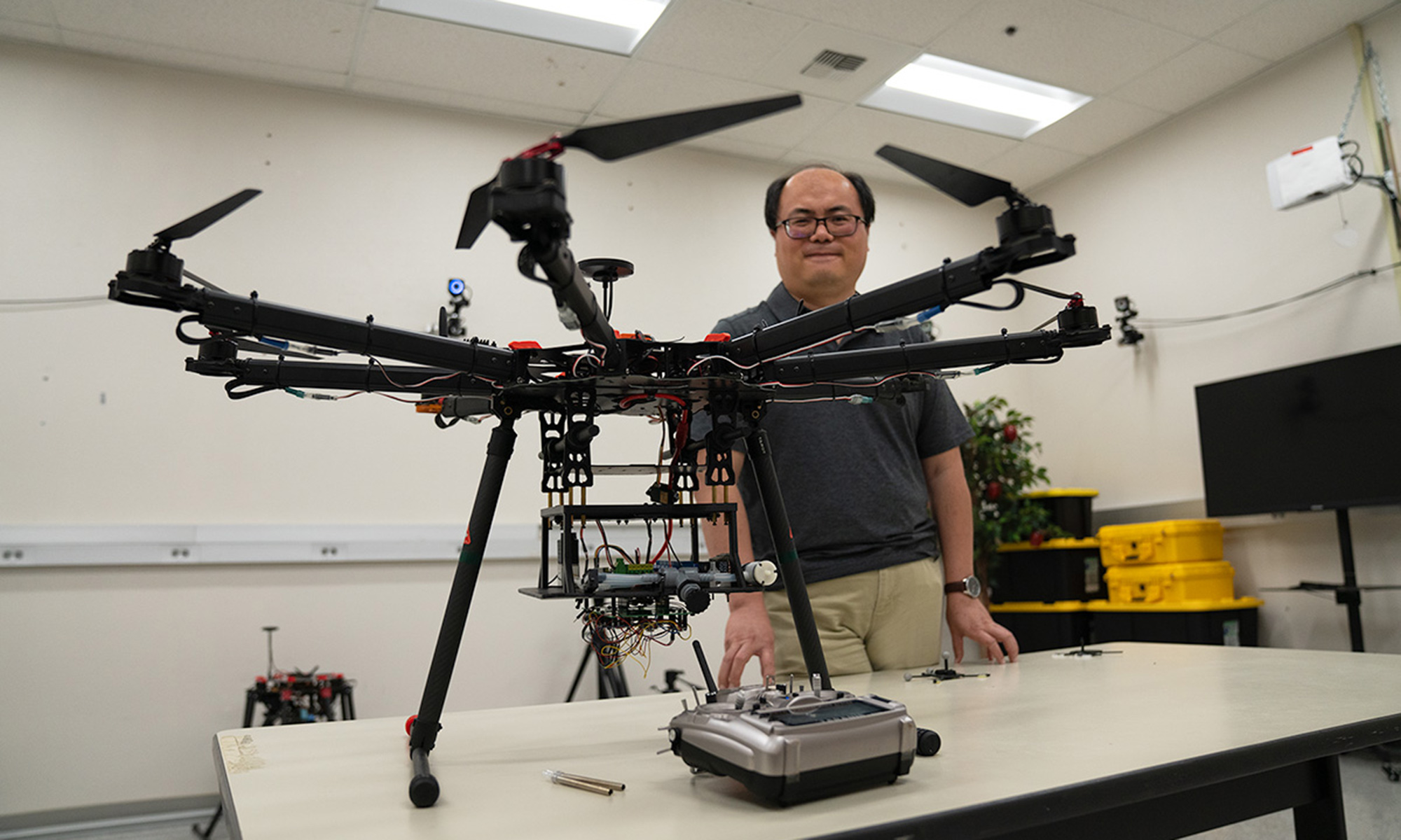 Researcher Zhaodan Kong stands behind wildfire drone