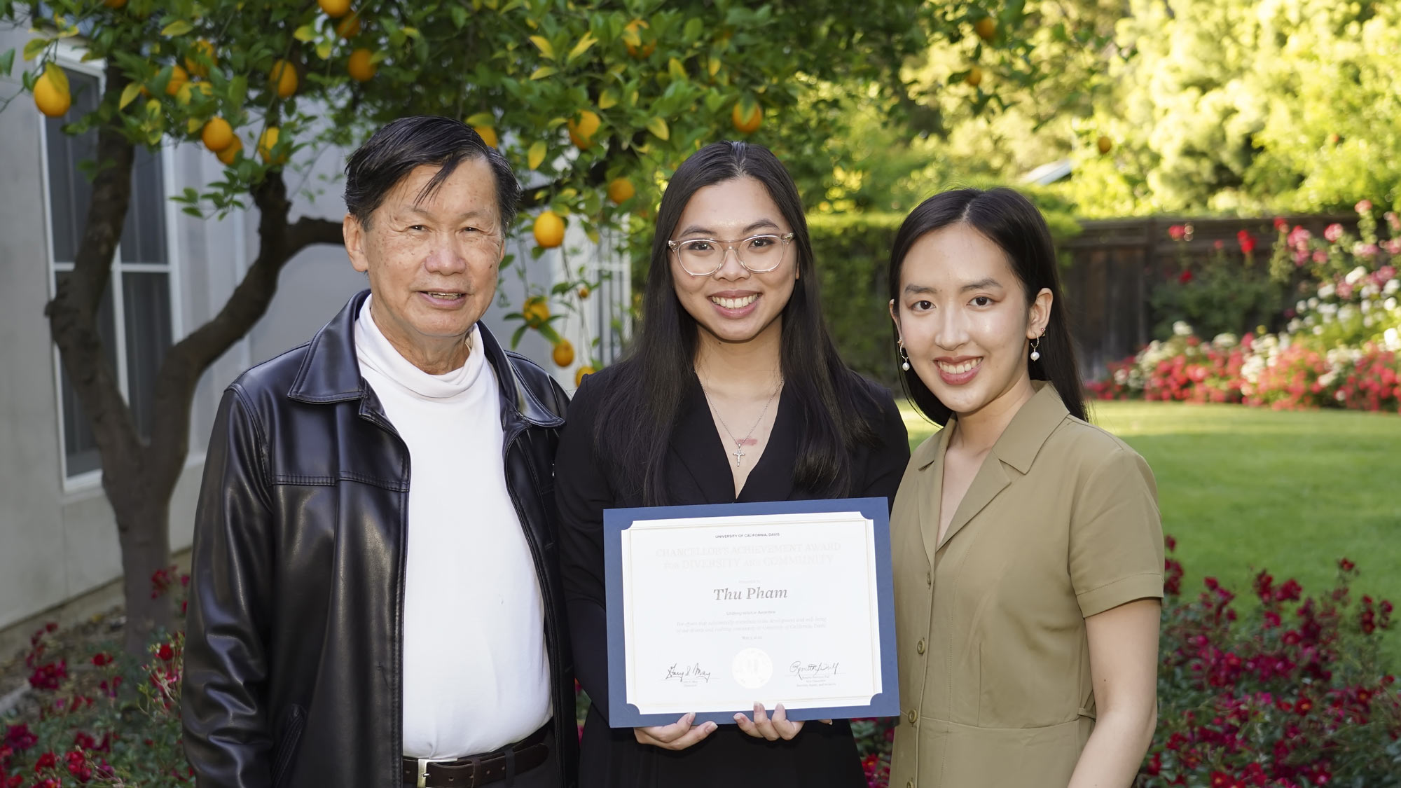 Three people, including undergraduate award recipient, posed, environmental