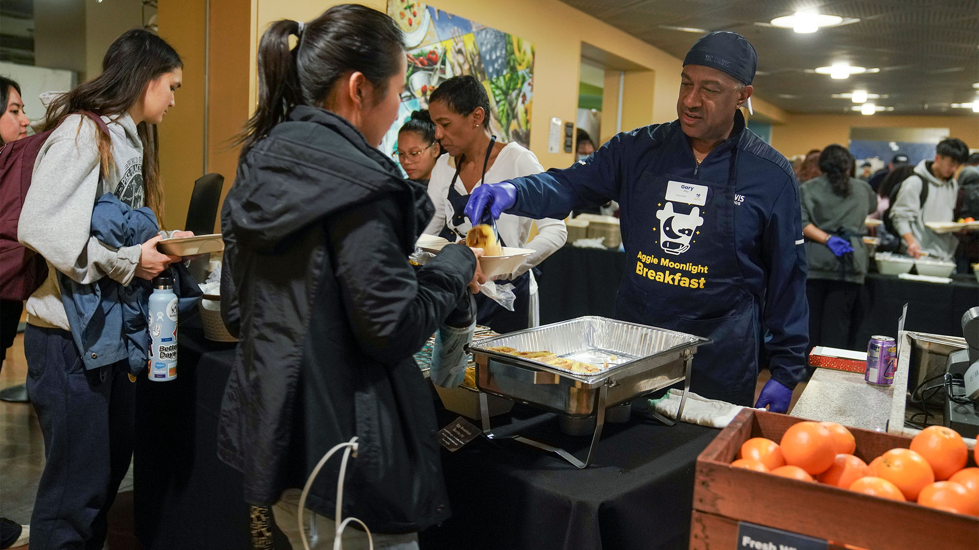 Chancellor May and LeShelle May serving food