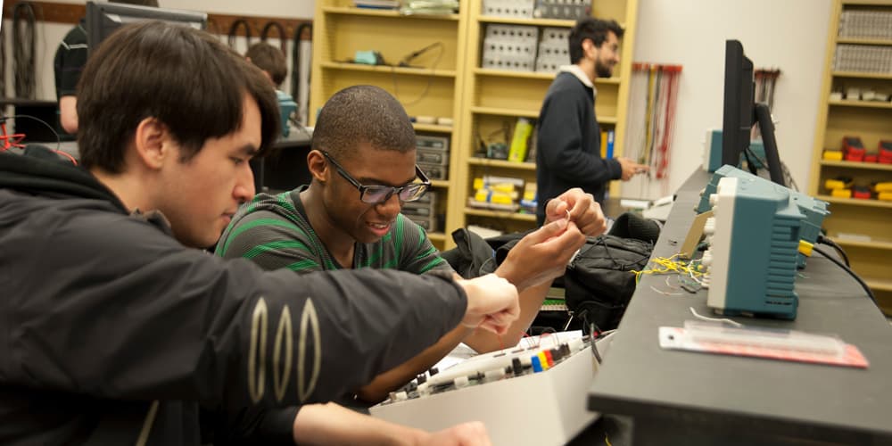 two students working on a project in an engineering lab