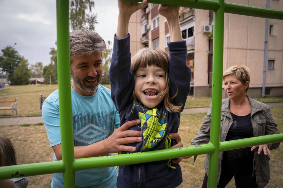 family plays on playground