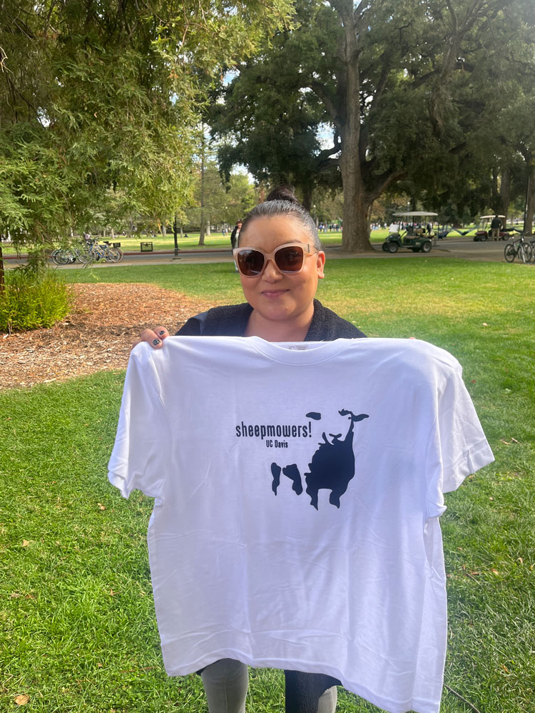 Student with shirt they finished in a screenprinting class showing a sheep image