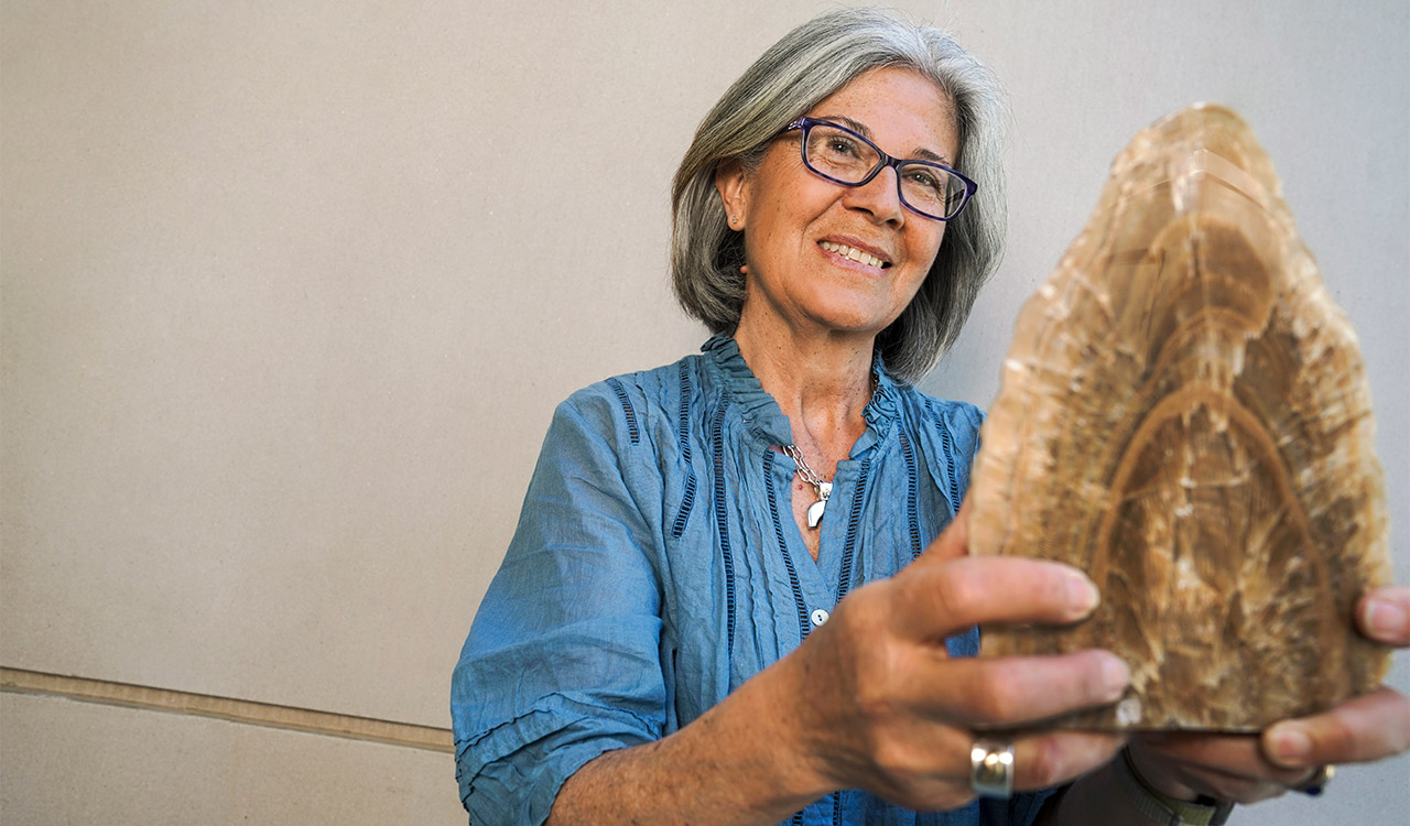 Woman holds fossil.
