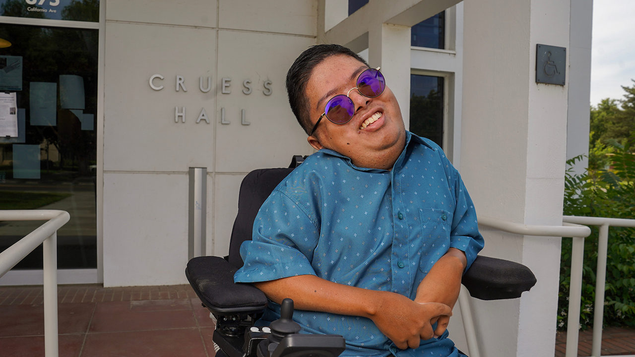 Closeup of Eduardo "Eddie" Landicho in his wheelchair outside Cruess Hall