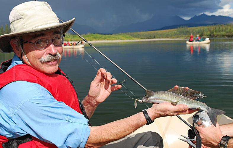 Peter Moyle fishing from boat on Alaska's Kobuk River