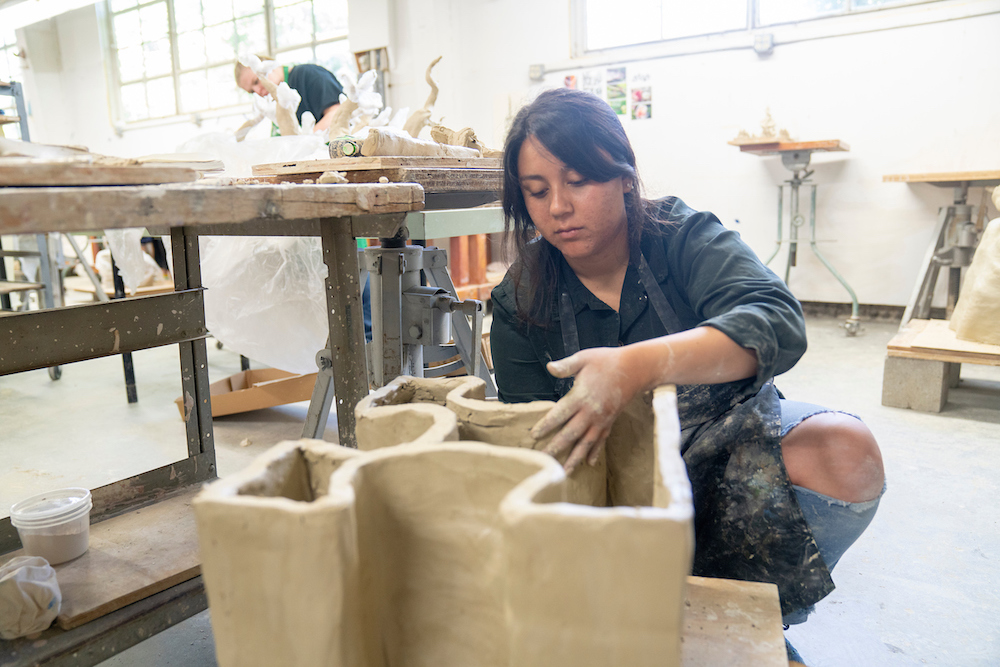 A student molds a ceramic piece at UC Davis. 