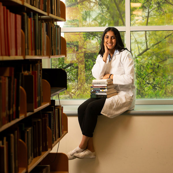 A medical student takes a break from her studies in the library 