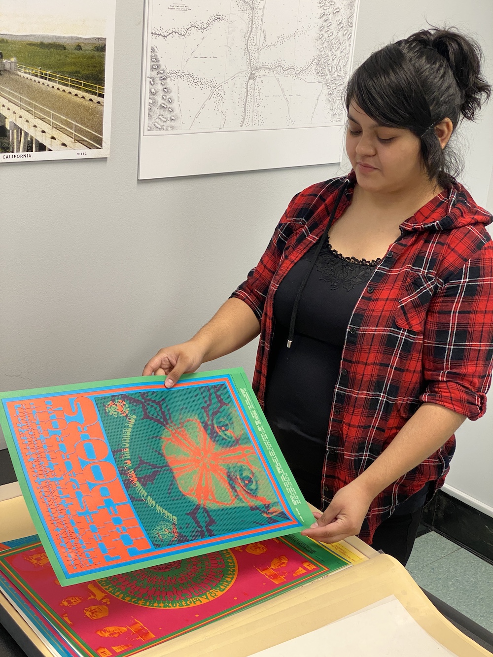 A student looks at a brightly colored poster at UC Davis. 