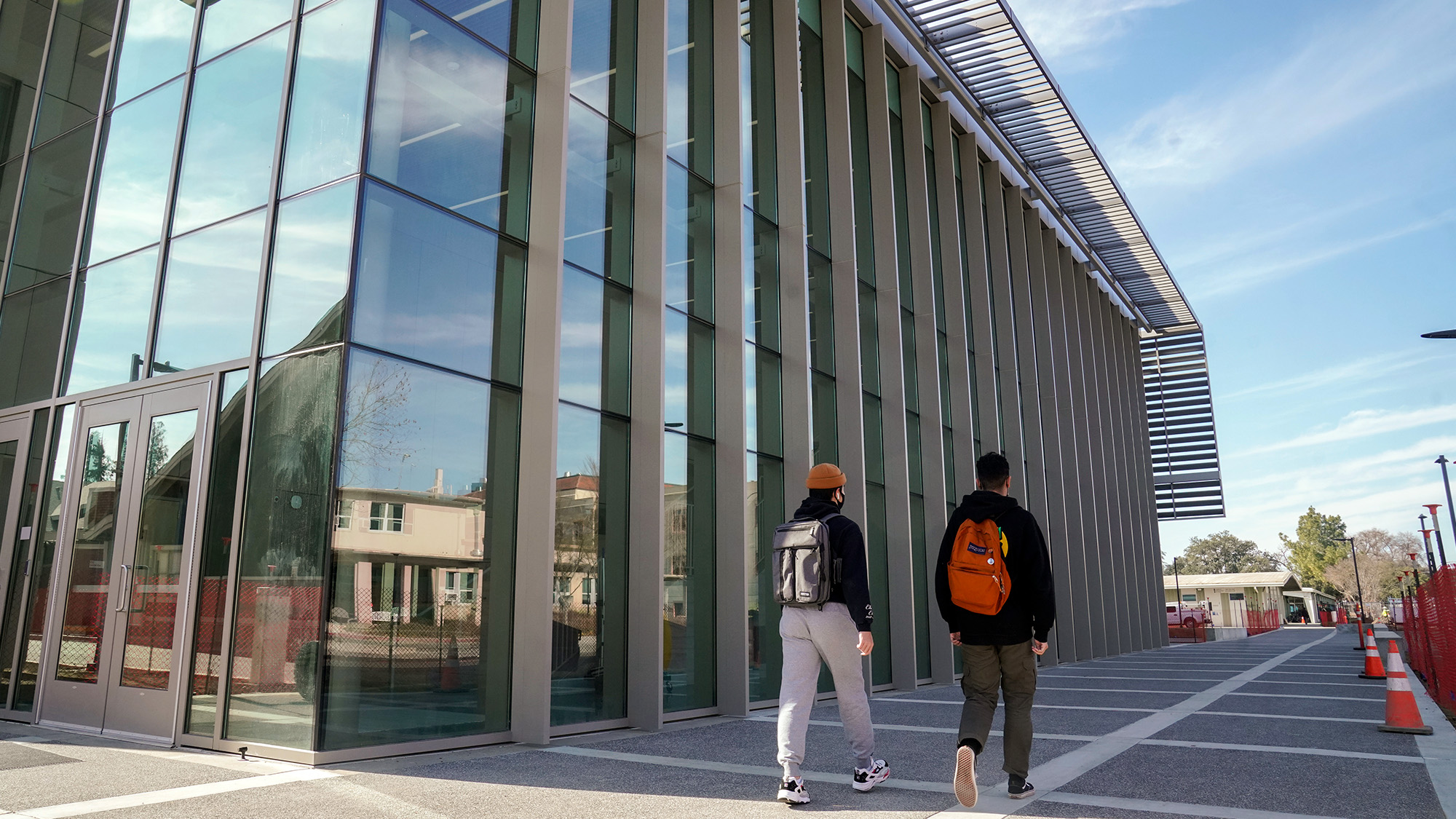 Two students walk past the Teaching and Learning Complex.