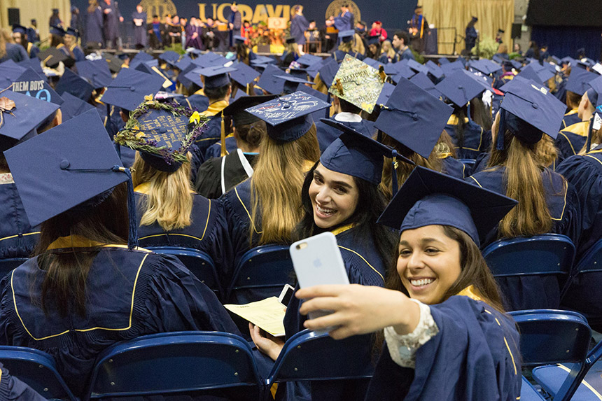 Graduating students take a selfie at commencement.