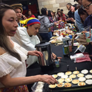 Students cook food for the International Student Fair.