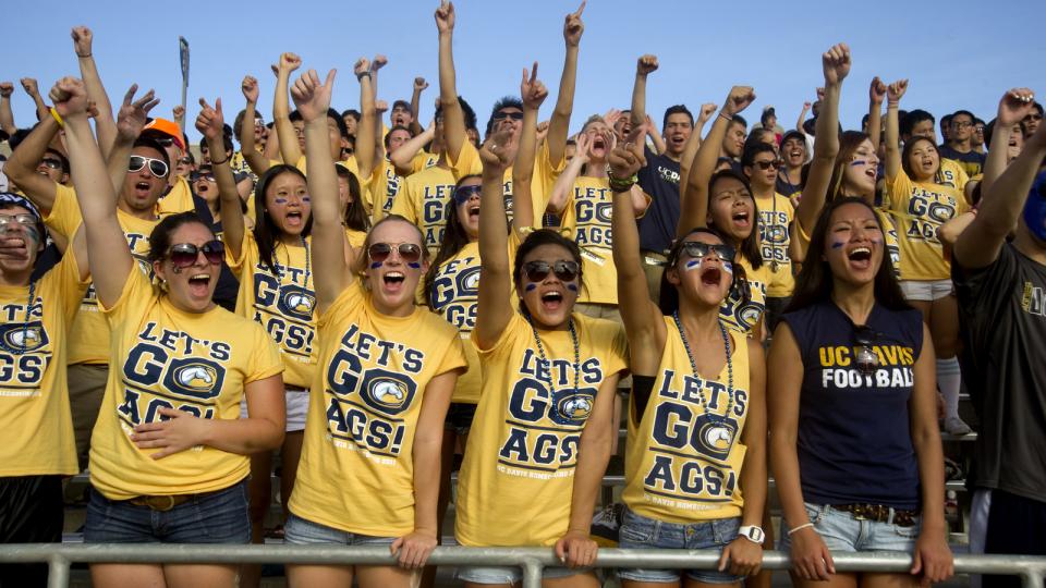 Students in UC Davis T-shirts, cheering.