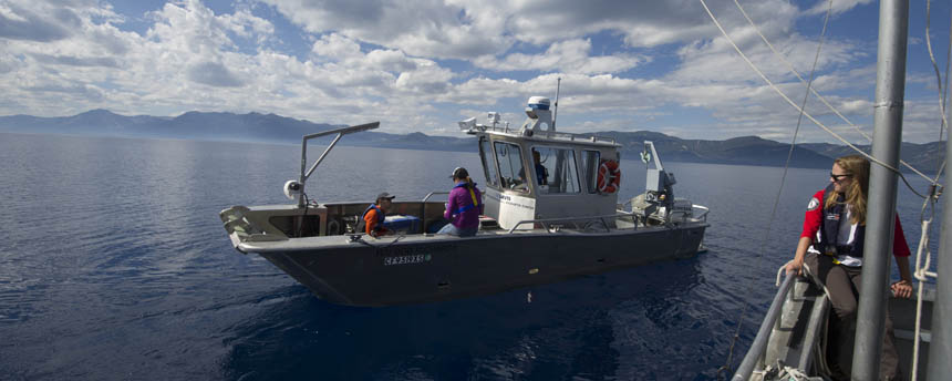 Two research boats manned by science students float on Lake Tahoe
