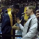 Two people shake hands at commencement