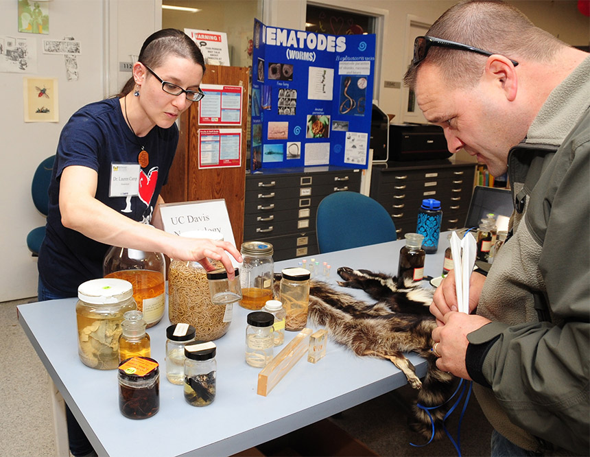 Lauren Camp shows nematodes to a visitor.