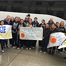 Fans welcome the women's basketball team back to campus.