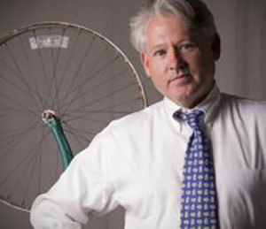 James Housefield against backdrop of bicycle wheel