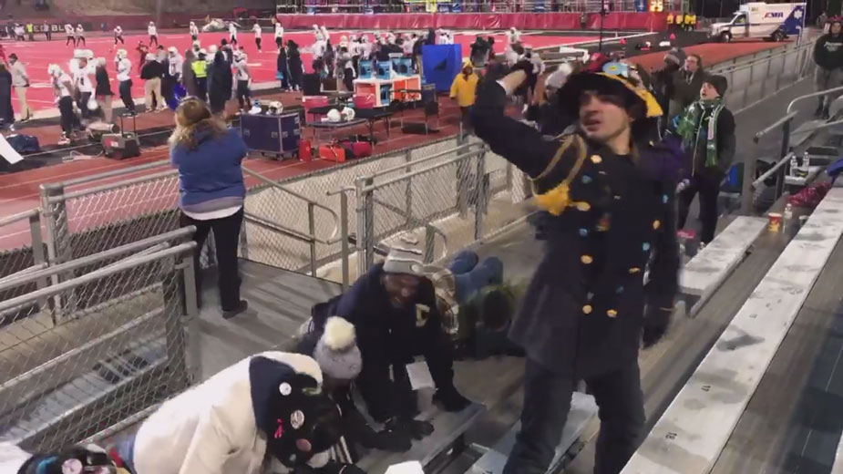 Chancellor May and LeShelle May and others, doing push-ups in the stands.