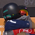 Two skiers embrace.